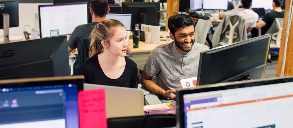 Two people collaborating on a computer