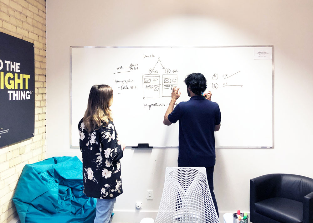 UX researchers brainstorming on a whiteboard